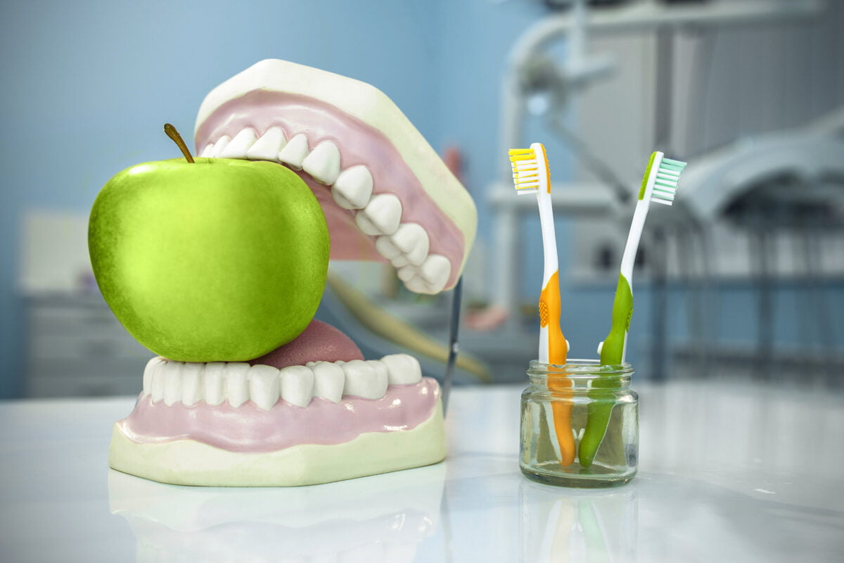 composition-denture-apple-toothbrushes-glass-dental-surgery.jpg